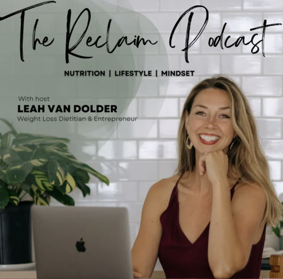 Leah sitting at desk with macbook in front of her. Words describing the Reclaim Podcast with Leah Van Dolder